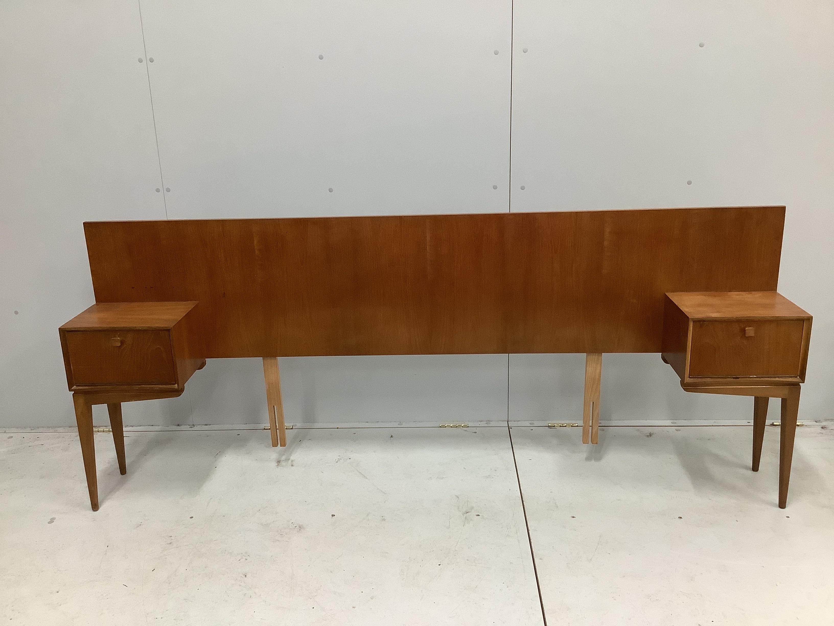 McIntosh of Kirkaldy, a mid century teak kneehole dressing table, width 141cm, depth 46cm, height 117cm together with a matching headboard with integral cupboards